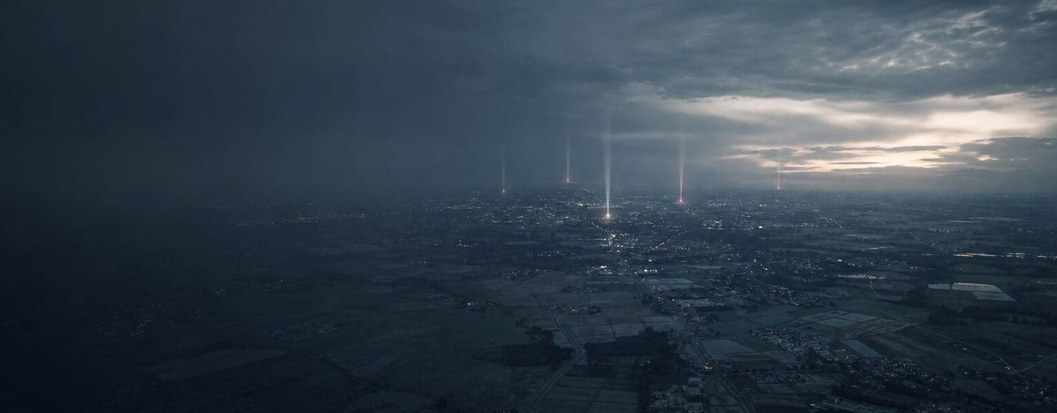Aerial dusk view of rooftops with faint signal glow, representing a mobile coverage checker